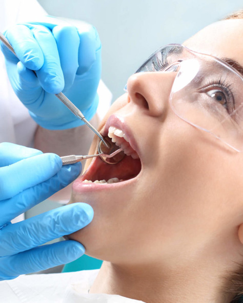 Dentist performing Root Canal Therapy Hamilton on young female patient