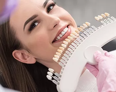 Hamilton dentist comparing dental veneers to beautiful patient's smile