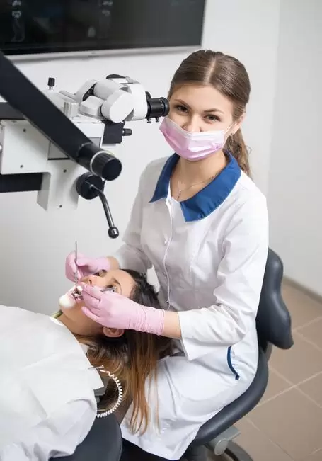 Calm dental hygienist performing emergency procedure on patient